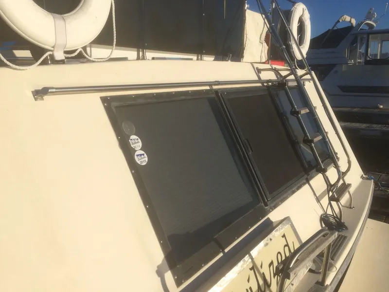 Slide: The Image of 1985 Bluewater 42 Coastal Cruiser with life rings and ladder on deck. - 2