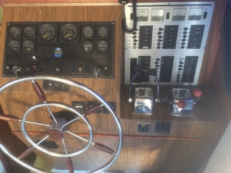 Slide: The Image of Control panel of a 1985 Bluewater 42 Coastal Cruiser with steering wheel and gauges. - 20