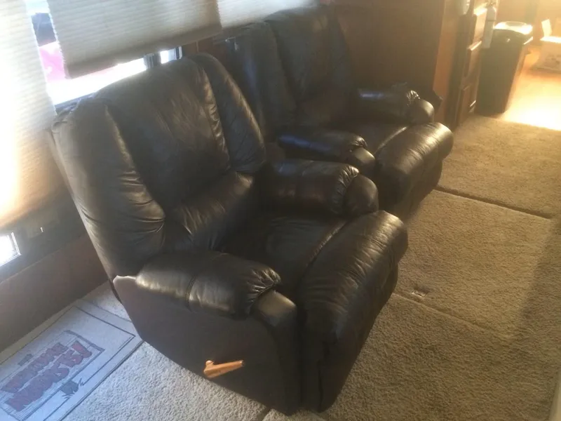 Slide: The Image of Black leather recliners in a cozy interior of a 1985 Bluewater 42 Coastal Cruiser. - 21