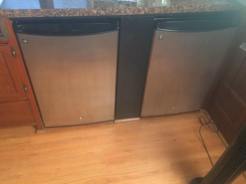 Slide: The Image of Two stainless steel mini fridges in a Bluewater 42 Coastal Cruiser, 1985 model. - 25