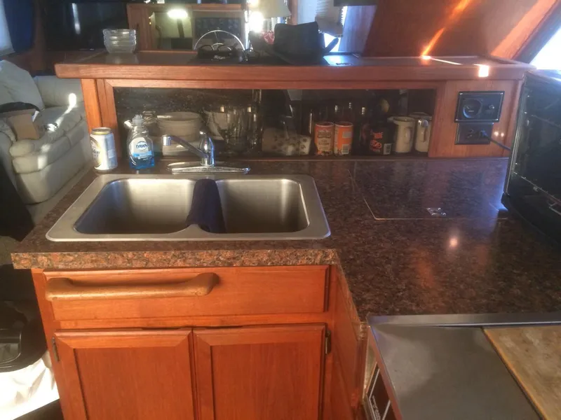 Slide: The Image of Interior of 1985 Bluewater 42 Coastal Cruiser kitchen with sink and wooden cabinetry. - 26