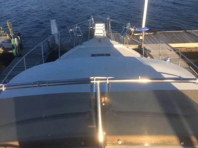 Slide: The Image of 1985 Bluewater 42 Coastal Cruiser docked, viewed from the deck, with water and pier in background. - 5