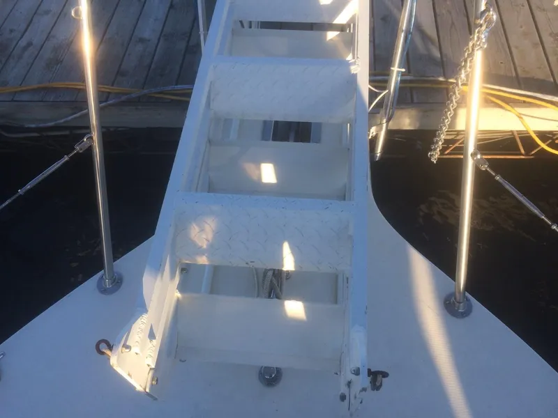 Slide: The Image of Staircase on 1985 Bluewater 42 Coastal Cruiser, docked with visible railing and deck. - 7