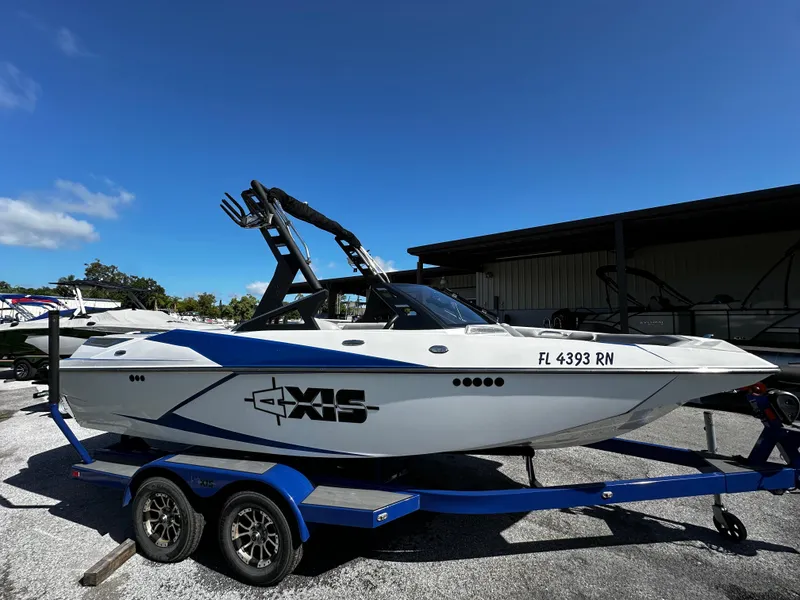 Slide: The Image of 2018 Axis A20 boat on trailer under clear blue sky. - 17