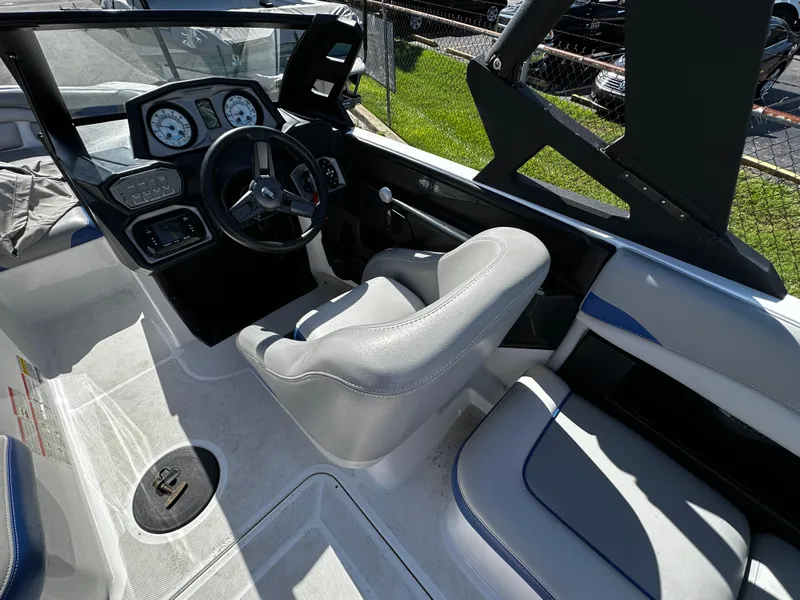 Slide: The Image of 2018 Axis A20 boat interior with steering wheel and dashboard. - 22