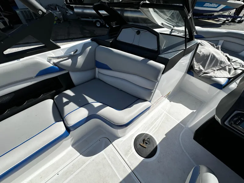 Slide: The Image of 2018 Axis A20 boat interior with white and blue seating, sleek design. - 23