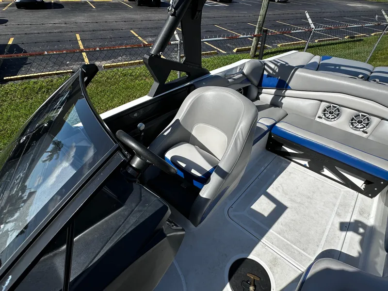 Slide: The Image of 2018 Axis A20 boat interior with steering wheel and seating. - 27