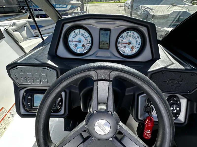 Slide: The Image of 2018 Axis A20 boat dashboard with steering wheel and gauges. - 30