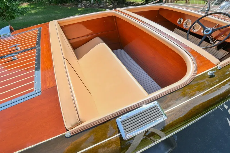 Slide: The Image of 1942 Chris-Craft 17 classic wooden boat interior with tan leather seats and polished wood finish. - 10