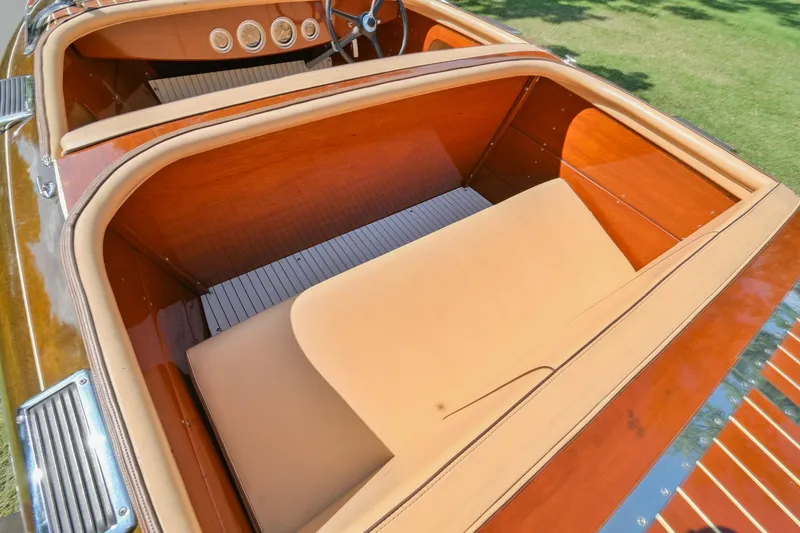 Slide: The Image of 1942 Chris-Craft 17 classic boat interior with wooden finish and beige upholstery. - 11