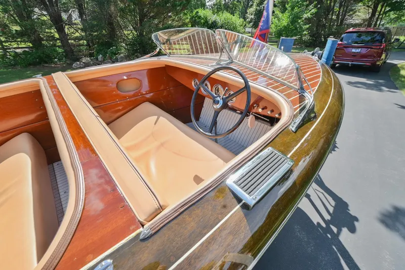 Slide: The Image of 1942 Chris-Craft 17 classic wooden boat with tan interior and vintage steering wheel. - 16