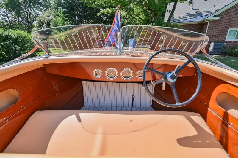 Slide: The Image of 1942 Chris-Craft 17 boat interior with vintage steering wheel and dashboard. - 17