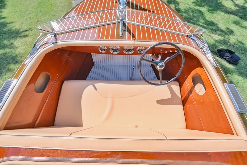 Slide: The Image of 1942 Chris-Craft 17 classic wooden boat interior with steering wheel and dashboard. - 18