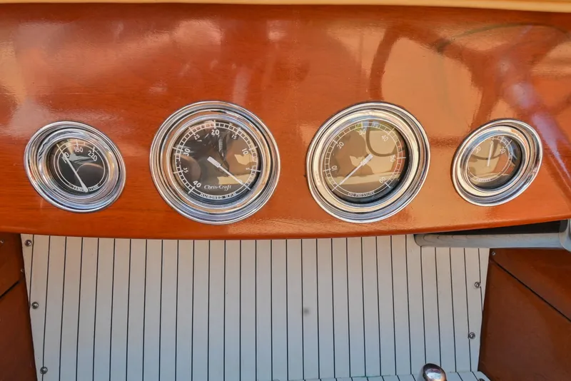 Slide: The Image of 1942 Chris-Craft 17 dashboard with classic gauges and wooden finish. - 21
