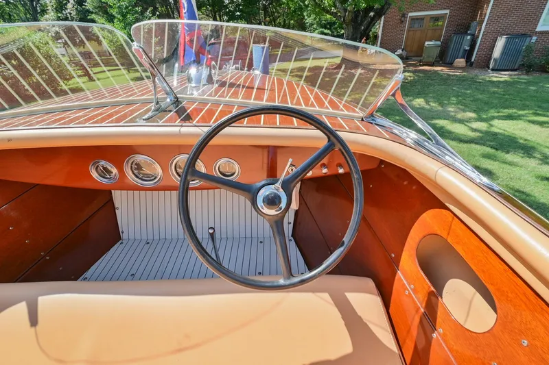 Slide: The Image of 1942 Chris-Craft 17 boat interior with steering wheel and dashboard gauges. - 22