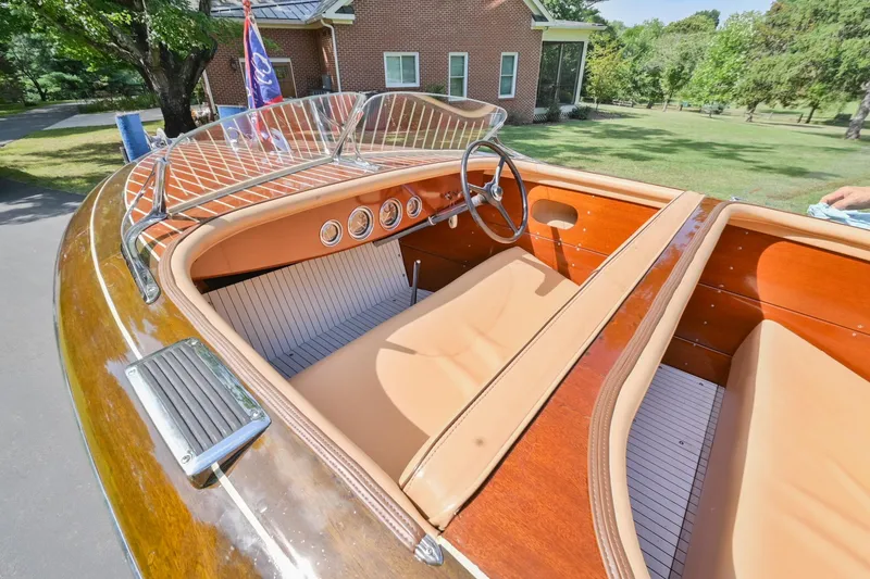 Slide: The Image of 1942 Chris-Craft 17 classic wooden boat interior with tan seats and vintage dashboard. - 23