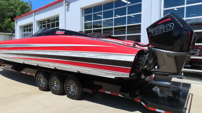 Slide: The Image of 2020 Wright Performance 360 boat with red, white, and black stripes on a trailer. - 10