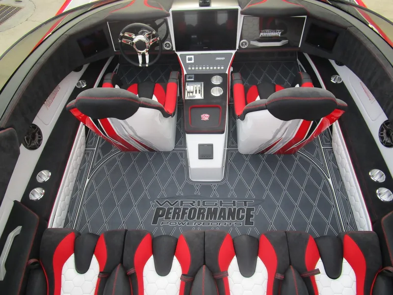 Slide: The Image of 2020 Wright Performance 360 boat interior with red and black seats, advanced dashboard, and branded flooring. - 33