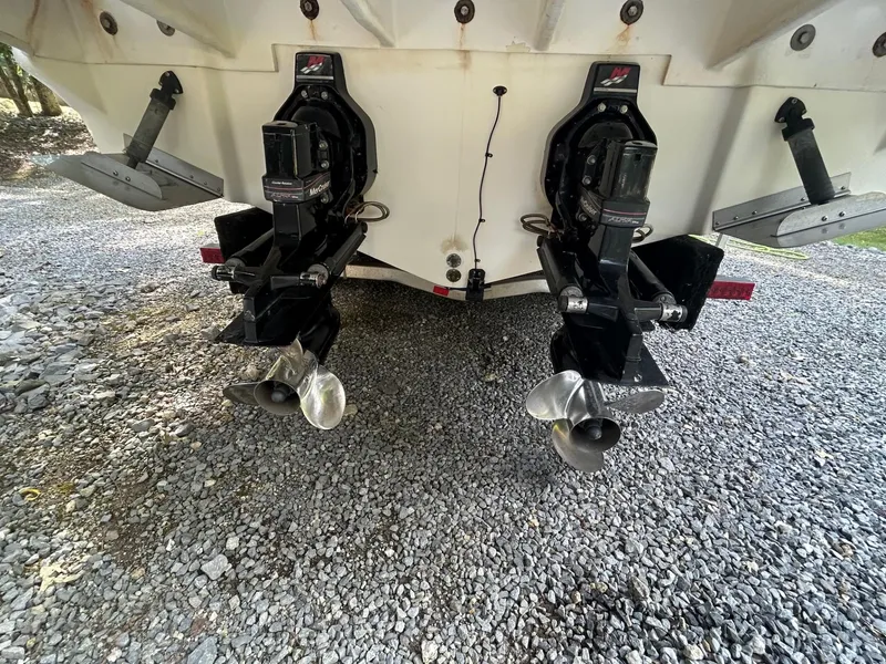 Slide: The Image of Rear view of 2008 Sea Ray 280DA boat with dual propellers on gravel. - 17