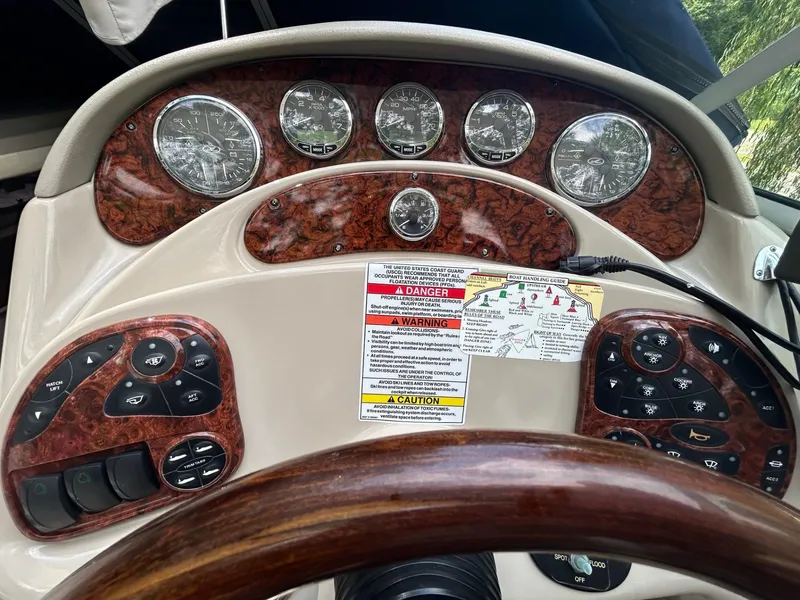 Slide: The Image of Dashboard of a 2008 Sea Ray 280DA boat with gauges and control panels. - 2