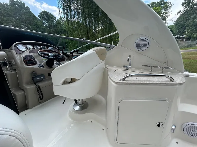 Slide: The Image of 2008 Sea Ray 280DA boat interior with helm, steering wheel, and sink area. - 7