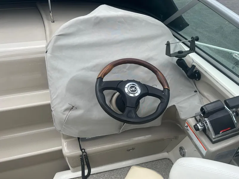 Slide: The Image of 2008 Sea Ray 280DA boat helm with covered dashboard and steering wheel. - 9