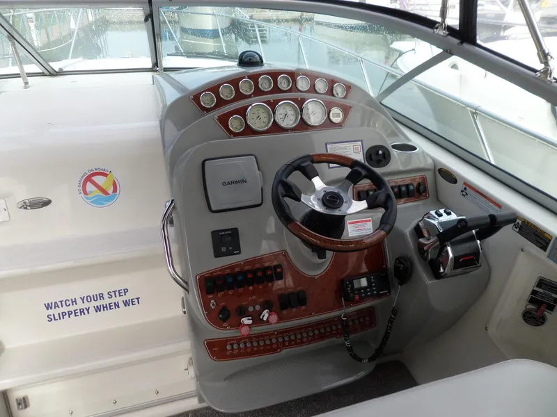 Slide: The Image of 2008 Bayliner 320 Express boat helm with steering wheel and control panel. - 10