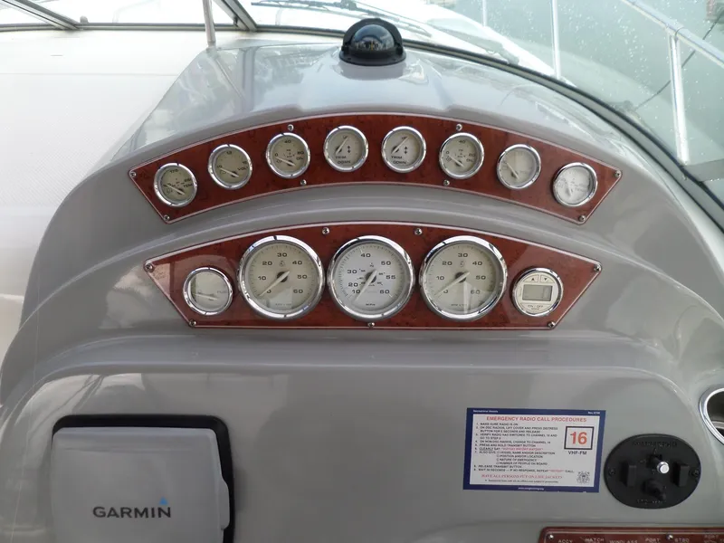 Slide: The Image of 2008 Bayliner 320 Express dashboard with gauges and Garmin navigation system. - 11