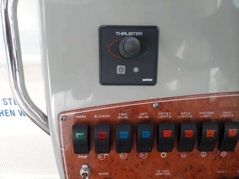 Slide: The Image of Control panel of a 2008 Bayliner 320 Express boat with thruster and various switches. - 13