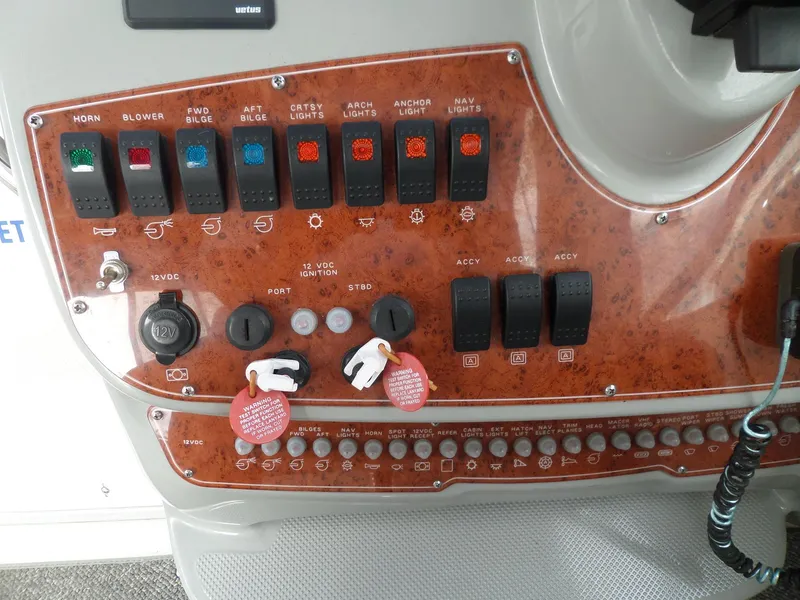 Slide: The Image of Control panel of a 2008 Bayliner 320 Express boat with various switches and indicators. - 14