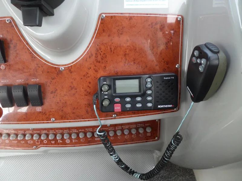 Slide: The Image of Control panel of a 2008 Bayliner 320 Express boat with radio and switches. - 15