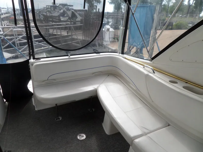Slide: The Image of 2008 Bayliner 320 Express boat interior with white seating and large windows. - 19