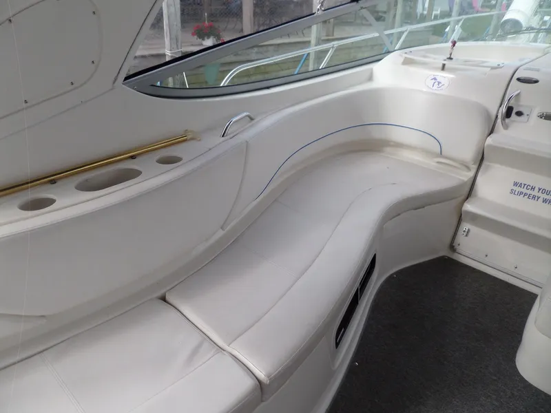 Slide: The Image of 2008 Bayliner 320 Express boat interior with white seating and cup holders. - 21