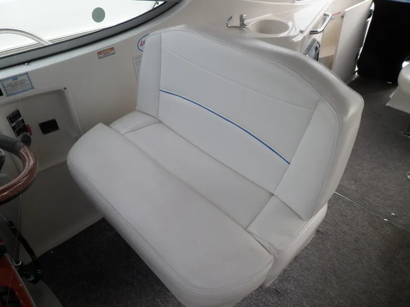 Slide: The Image of 2008 Bayliner 320 Express white leather seat in cockpit area. - 24