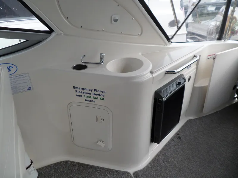 Slide: The Image of 2008 Bayliner 320 Express boat interior with emergency equipment storage. - 25