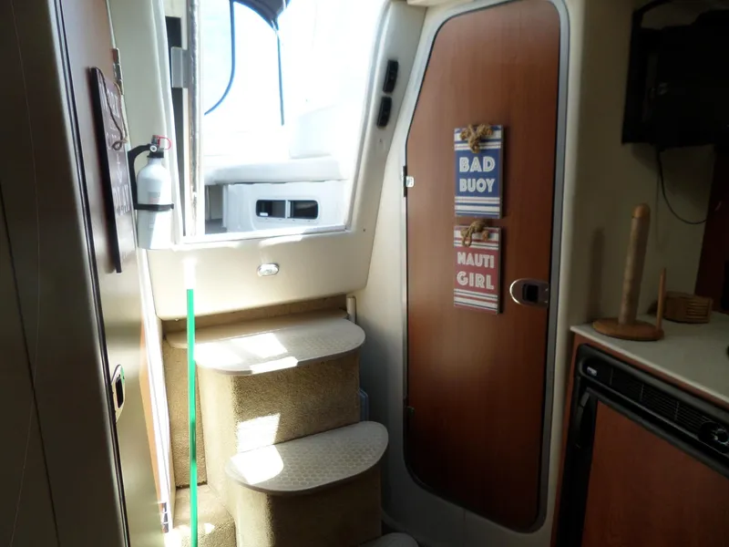Slide: The Image of Interior of 2008 Bayliner 320 Express with stairs, door, and nautical decor. - 36