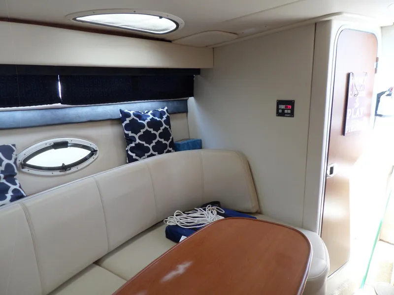 Slide: The Image of Interior of 2008 Bayliner 320 Express with beige seating and wooden table. - 38