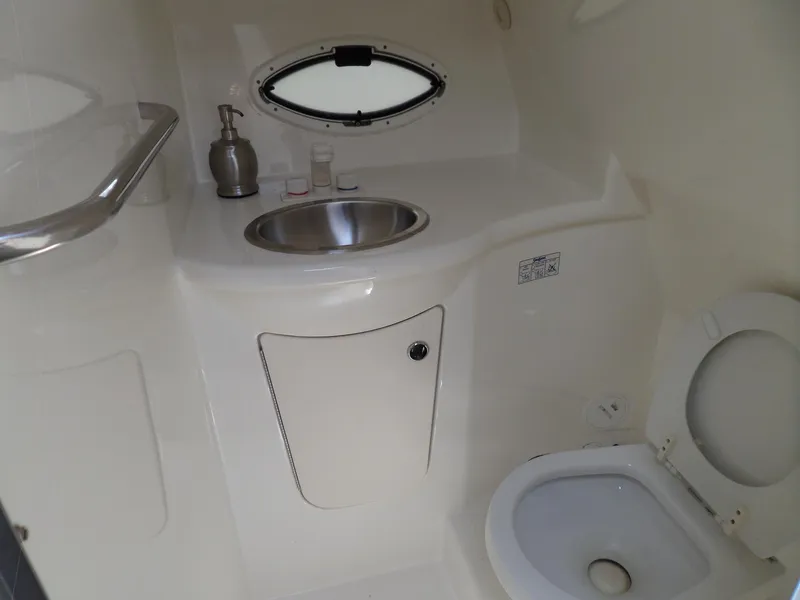 Slide: The Image of 2008 Bayliner 320 Express boat bathroom with sink and toilet. - 42