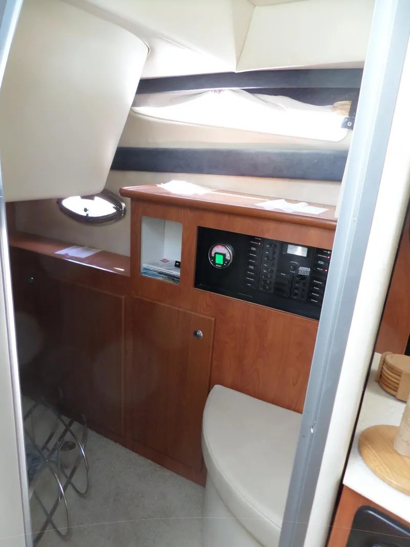 Slide: The Image of Interior cabin of a 2008 Bayliner 320 Express boat with wooden cabinetry and control panel. - 44