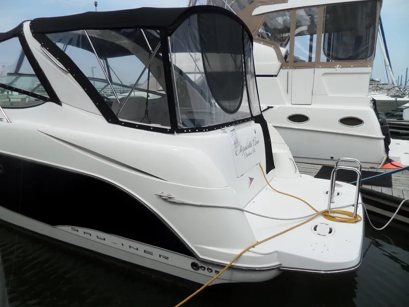 Slide: The Image of 2008 Bayliner 320 Express boat docked at marina with black canopy. - 7