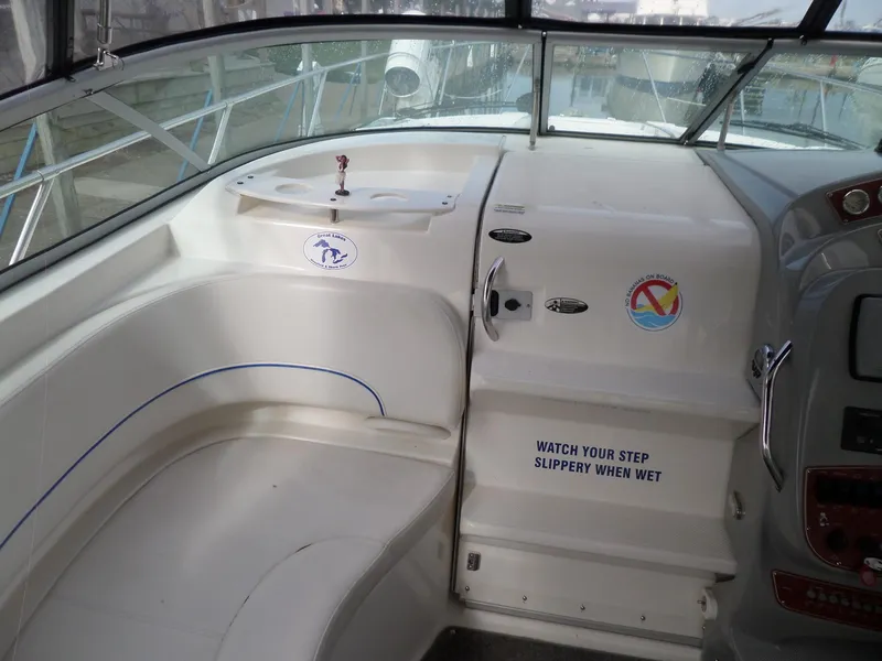 Slide: The Image of 2008 Bayliner 320 Express boat interior with seating and safety warning. - 9