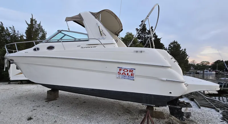 The Image of 1999 Sea Ray 290 Sundancer boat for sale, displayed on land. - 0