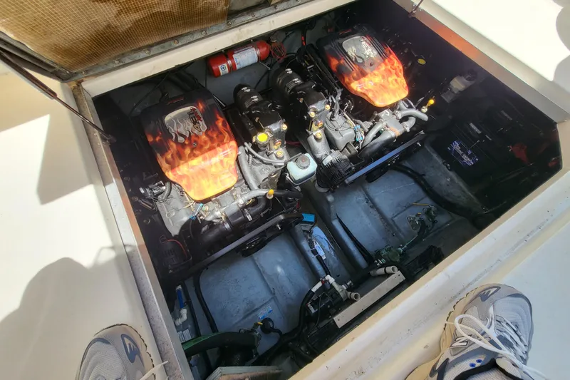Slide: The Image of Engine compartment of a 1999 Sea Ray 290 Sundancer with dual engines and fire extinguisher. - 2