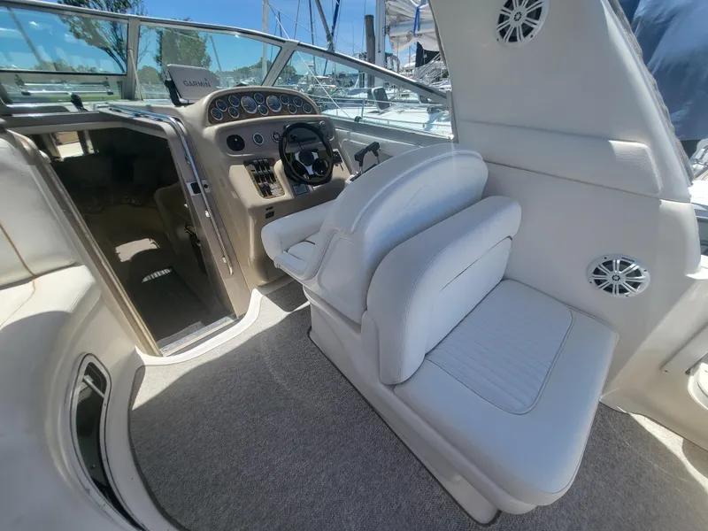 Slide: The Image of 1999 Sea Ray 290 Sundancer boat interior with helm and seating area. - 23