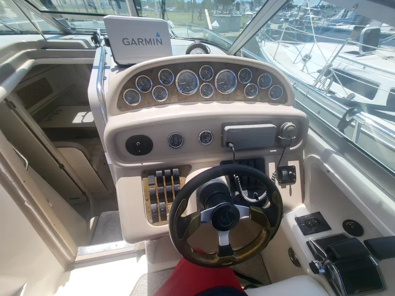 Slide: The Image of 1999 Sea Ray 290 Sundancer helm with Garmin navigation system and classic instrument panel. - 25