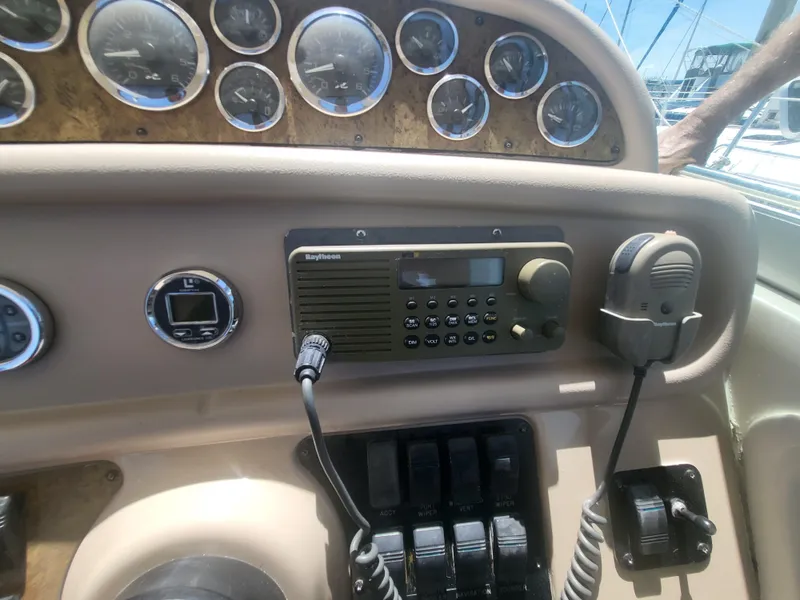 Slide: The Image of Control panel of a 1999 Sea Ray 290 Sundancer boat with gauges and radio equipment. - 27