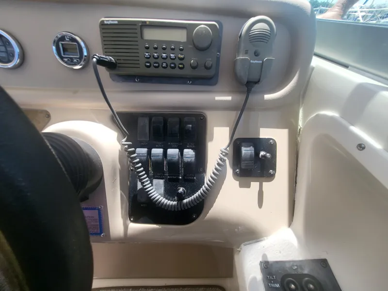 Slide: The Image of Control panel of a 1999 Sea Ray 290 Sundancer boat with radio and switches. - 29