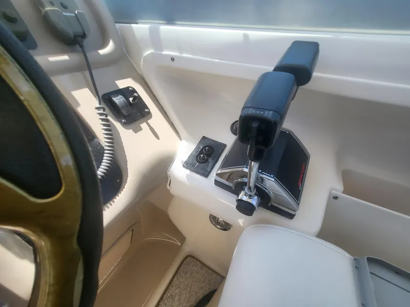 Slide: The Image of 1999 Sea Ray 290 Sundancer boat controls and steering wheel close-up. - 30