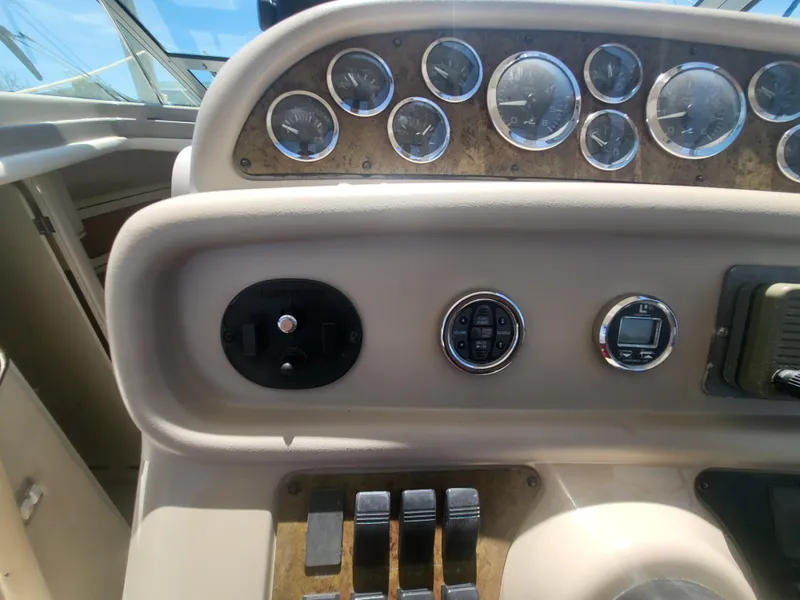 Slide: The Image of Dashboard of a 1999 Sea Ray 290 Sundancer boat with gauges and controls. - 32