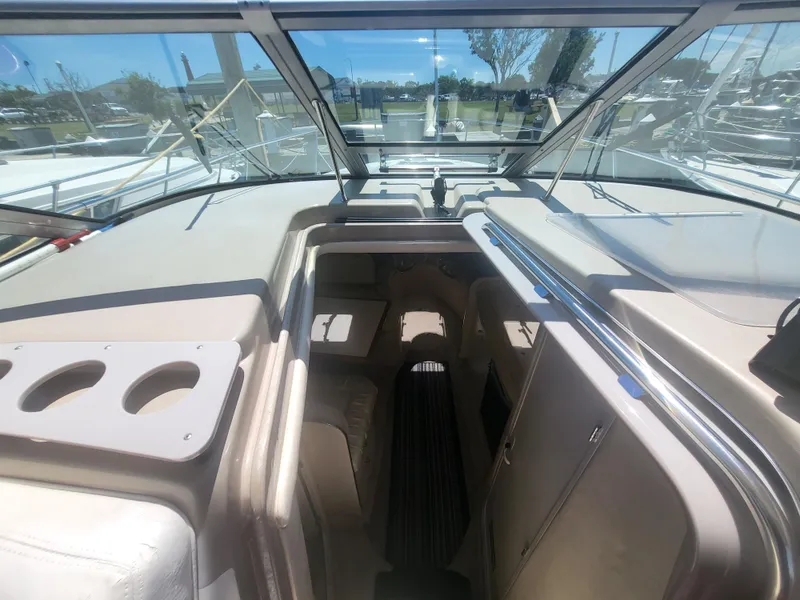 Slide: The Image of 1999 Sea Ray 290 Sundancer interior with cockpit view and seating area. - 33